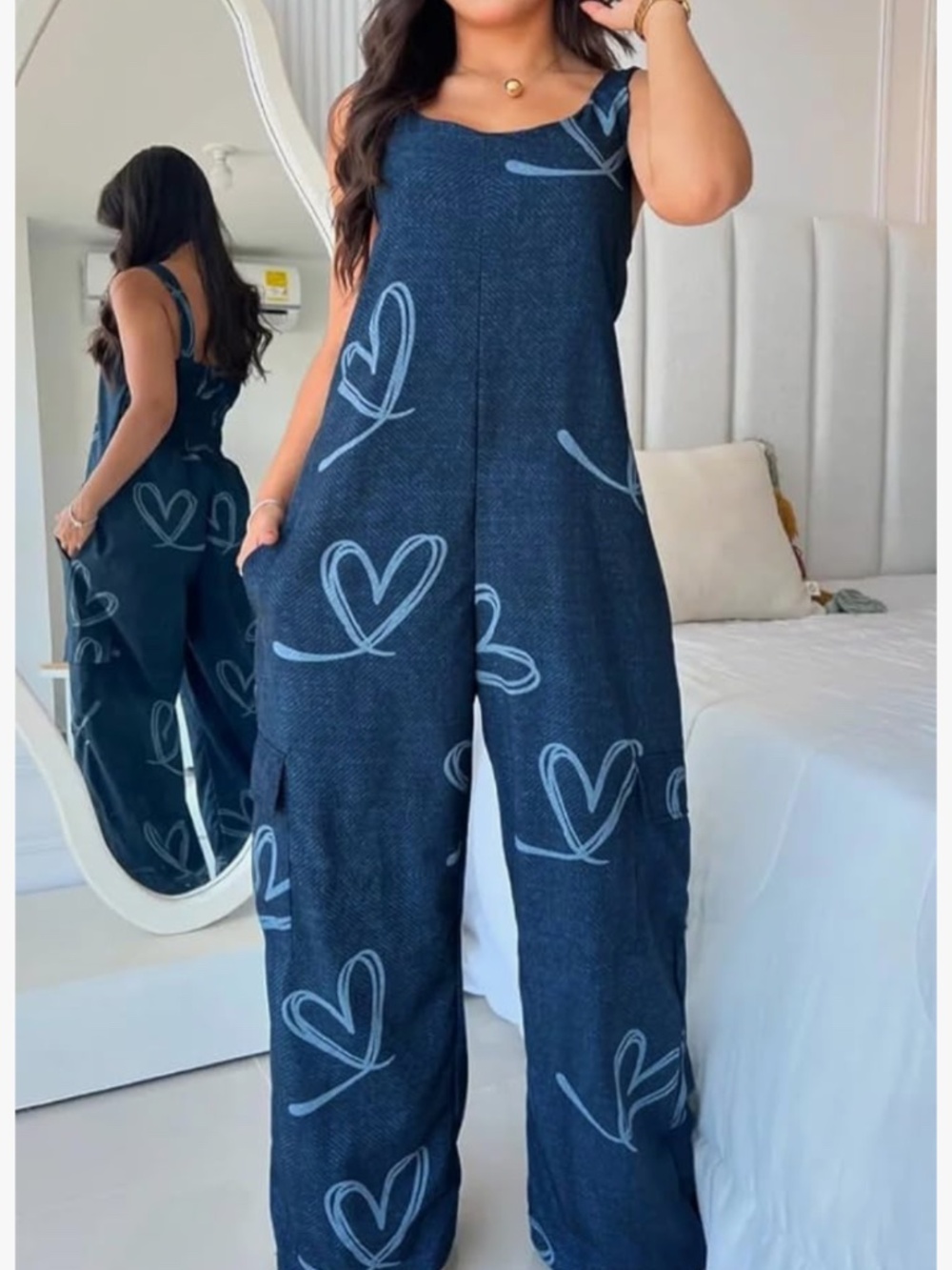 Relaxed wide-leg jumpsuit with a playful large heart print. Sleeveless design w